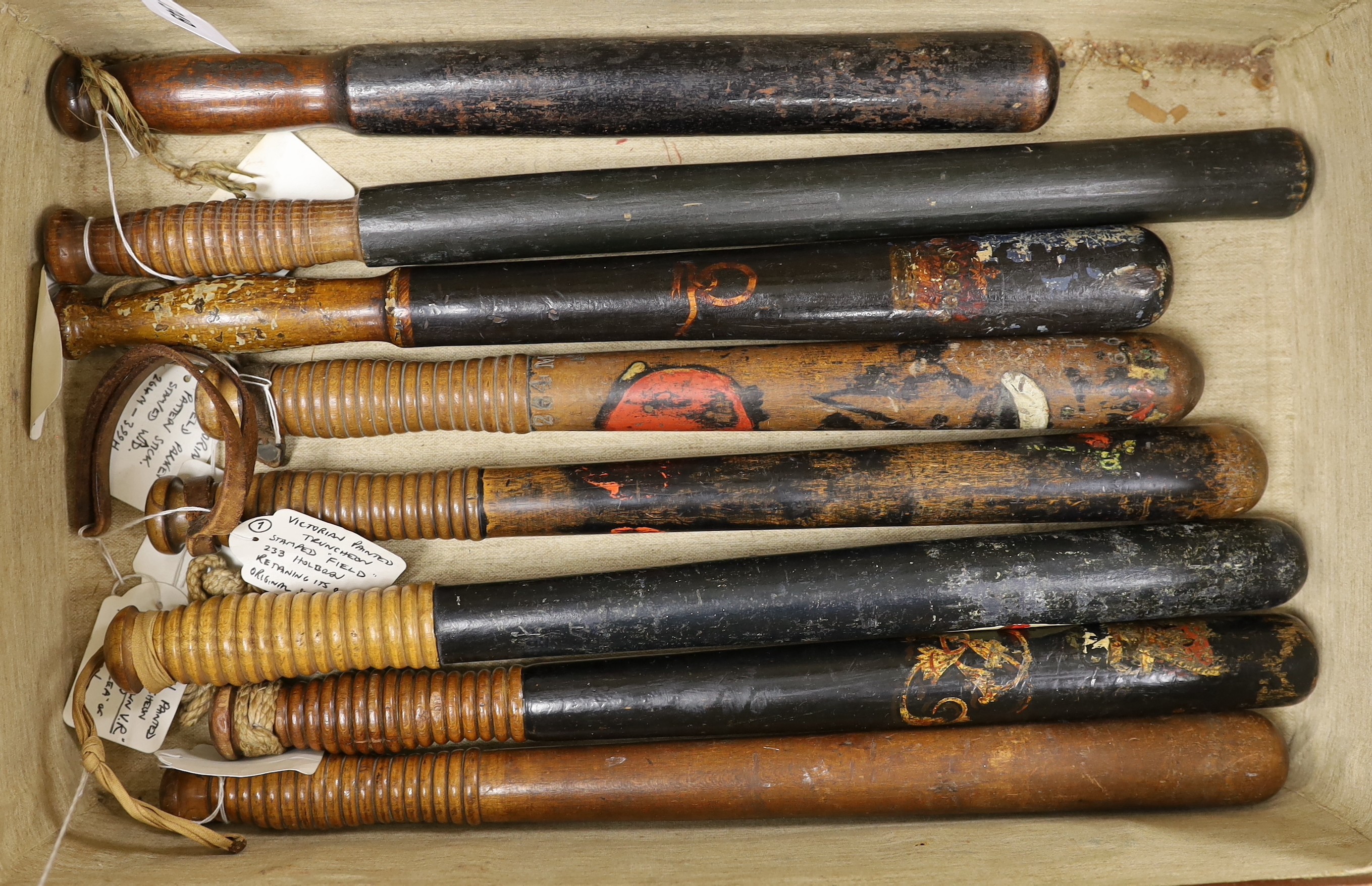 Eight Victorian truncheons, mostly painted, in suitcase